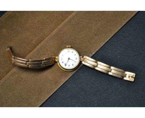 A lady's 9ct gold cased wristwatch, white dial, Arabic numerals, manual movement, 9ct gold triple row expanding bracelet stra