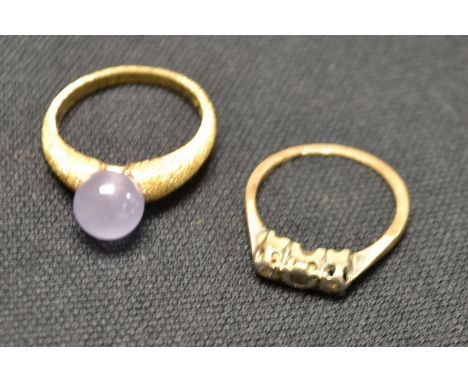 An Edwardian threestone diamond ring, platinum chains, 18ct gold shank; another amethyst and 9ct gold dress ring (2) 