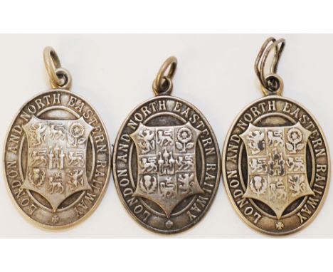 LNER Silver Passes, three in total. The first is engraved 'No A131 L. Meara Scottish Area'. The second 'A55 J. Wilkie Scottis