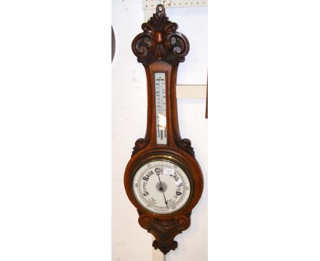 A Victorian oak barometer/thermometer in carved surround - 90cms