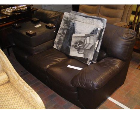 A brown leatherette three seater sofa with matching footstool 