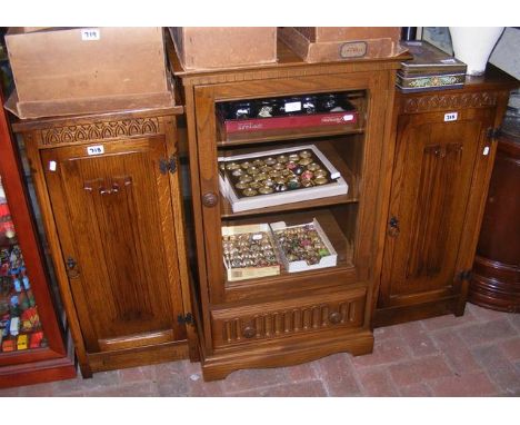 An Ercol music system cabinet, together with a pair of CD cupboards 