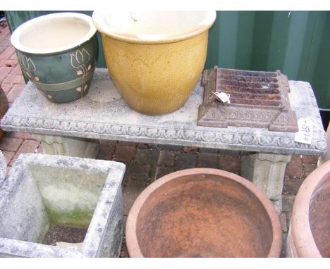 A concrete garden bench on plinths 