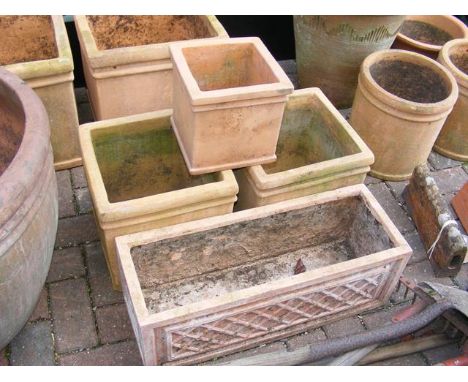 Three square terracotta plant pots and a rectangular planter 