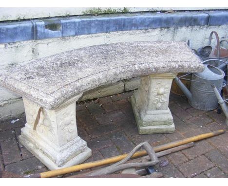 A stone garden bench on plinths - length 116cm 