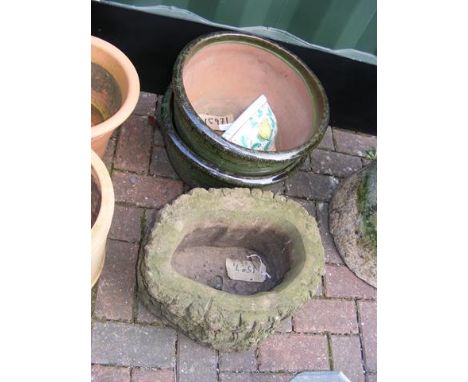 A pair of glazed terracotta plant pots, Mediterranean wall planter and a 'tree bark' stone planter 