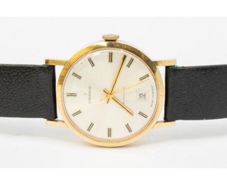 A gents 9ct gold cased Garrard automatic wristwatch, comprising a round signed silvered dial with applied baton markers, date