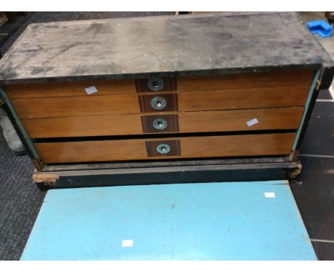 An Edwardian tool chest with four drawers containing vintage wood handled chisels and other vintage tools.