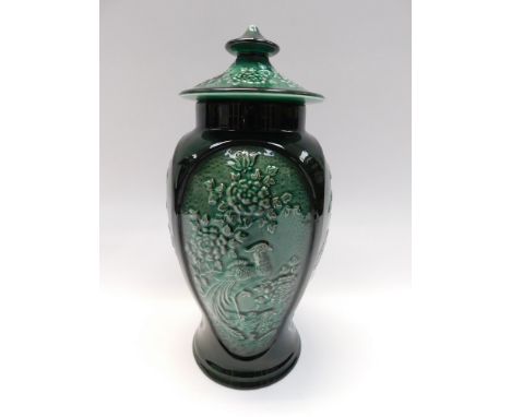 A Sylvac, green vase and cover with relief flowers and foliage design, marked to base, approx. 32cm high. Crazed, surface mar