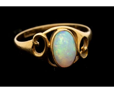 Murrle Bennett - an Art Nouveau opal and 18ct gold ring, comprising an oval opal within milled setting, open gold scrolled sh