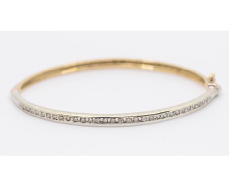 A diamond 9ct yellow and white gold hinged bangle, the top set with 30 small diamonds, width approx 3mm, internal diameter ap