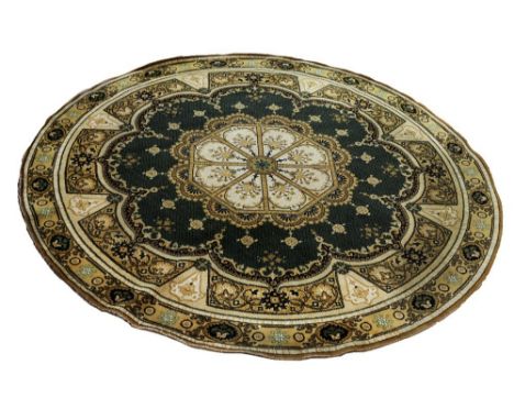 A mid to late 20th century circular shaped wool carpet, of green and gold colourway with central octagonal design with scroll