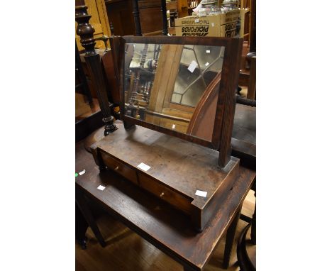 A George III mahogany toilet mirror with original peer glass and two trinket drawers.