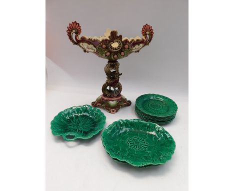 A collection of 19th Century Wedgewood Majolica sunflower green plates and bowls along with Majolica style table stand.