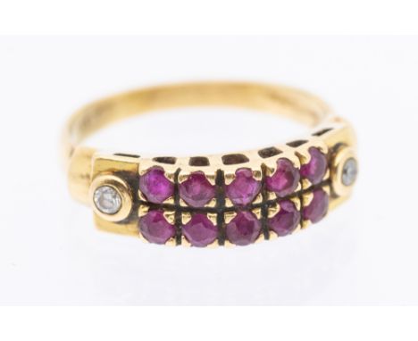 A diamond and ruby set 18ct gold ring, comprising a double row of claw set round cut rubies, with small collet set diamond se