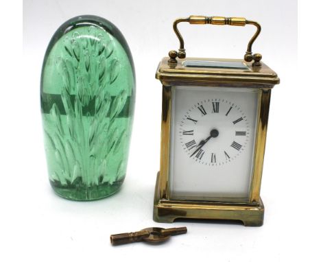 A 20th century brass-cased carriage clock, untested; together with a Victorian green glass dump/paperweight.
