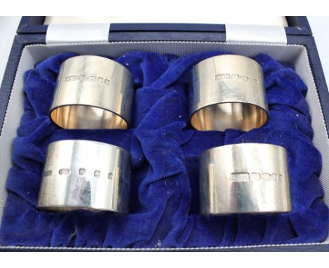 A matched set of four Modern silver napkin rings, of circular shape and plain design, hallmarked by Laurence R Watson & Co, L