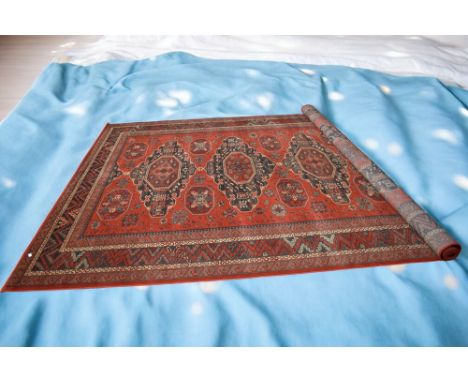 A large mid to late 20th Century deep red machine carpet with four central medallions, 360cm x 272cm.