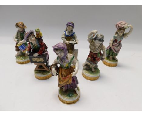 A set of six German Volkstedt porcelain figures comprising of a girl holding a basket of fruit, 13cm high; a girl with a bask