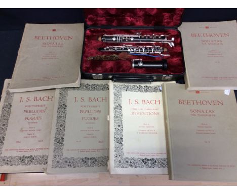 A Walter Winterbrown oboe in case with sheet music booklets.