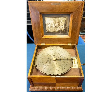 A 19th century walnut and mahogany cased table polyphon, having inlaid marquetry floral design to hinged lid; printed classic