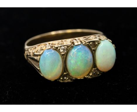 An opal and diamond set 9ct gold ring, comprising three graduated opals, within small diamond accents, width approx 9mm, size