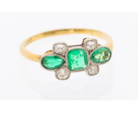An Art Deco diamond and emerald 18ct gold ring, comprising a central cushion cut emerald approx 4x4.5mm, with four old cut di