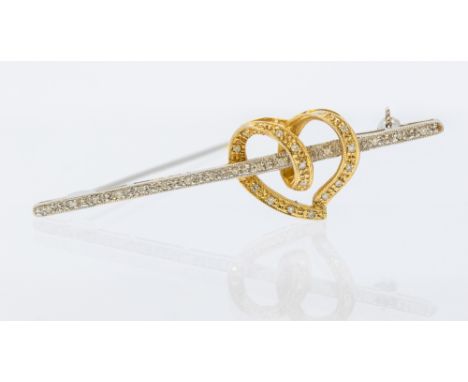 A diamond and 18ct gold two tone heart brooch, comprising a yellow gold openwork heart set with small diamonds, overlaid to a
