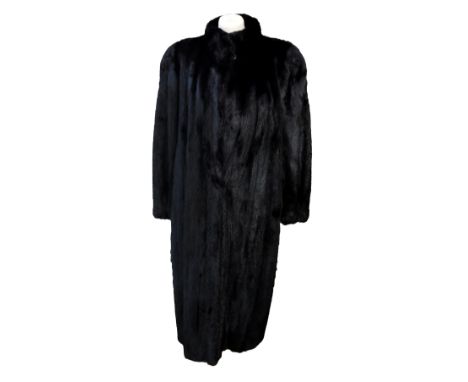 A black ranch mink coat, long length, made by Saga Mink, fully lined in black sateen-type fabric with embroidery and braid ed