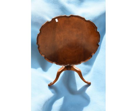 A 19th Century mahogany pole screen, a 19th Century mahogany pie crust tilt top table with tripod legs and a small oak carved