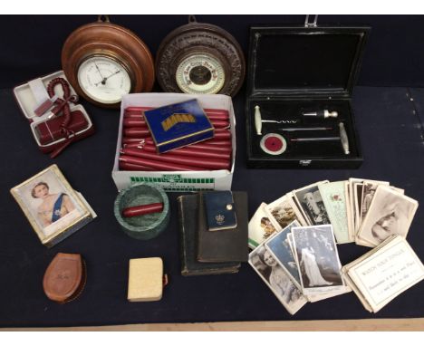 A collection of postcards, two wall barometers, shaver, candles, bibles and trinket boxes.