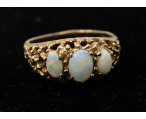 An opal and diamond set 9ct gold ring, comprising three graduated opals, within a fancy mount, width approx 9mm, size N1/2, t