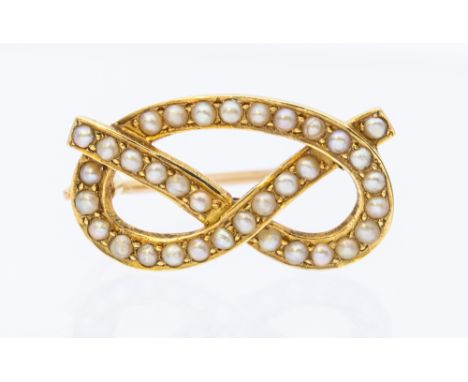 A vintage seed pearl set gold knot brooch, length approx 22mm, pin and C clasp, unmarked probably 15ct gold, total gross weig