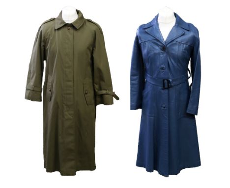 A sage green raincoat in a military style with epaulettes on shoulders and cuffs, matching green buttons, side pockets with b