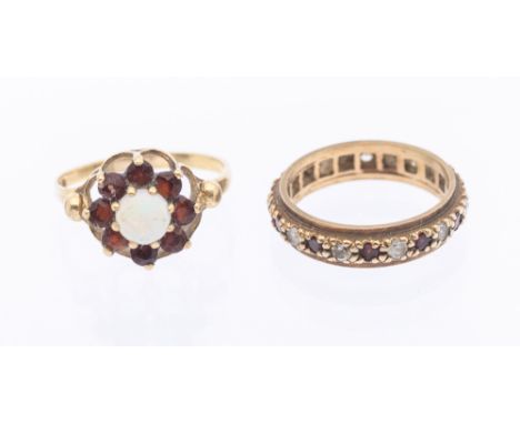 A garnet and white topaz 9ct gold full eternity ring, size L, together with a garnet and opal 9ct gold flower cluster ring, s