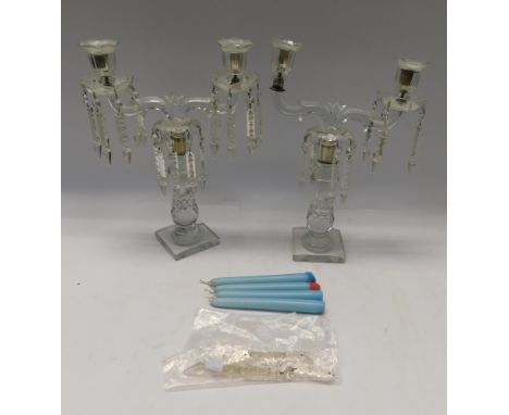 A pair of elaborate late 19th century glass candelabras with two scrolled sconces upon cut glass single candlestick with flut