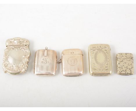 A silver engine turned vesta match case, another silver engine turned hinged case of similar size, an ornate vesta stamped St