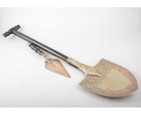 Edwardian electroplated ceremonial shovel, engraved blade, ebonised handle, 82cm; and an electroplated trowel. (2)