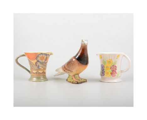 Beswick model of a pigeon, No.1383, 15cm; a Bursley Ware Charlotte Rhead jug; and a Radford Art pottery jug. (3)