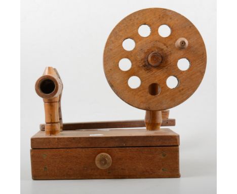 Oak bobbin winder and a small collection of wooden bobbins.