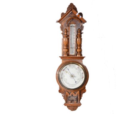 Edwardian oak aneroid barometer and thermometer, carved case, 87cm.
