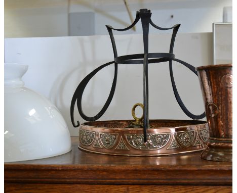 A copper mounted hanging oil lamp, the cast metal mounts having a 6cm embossed copper band holding the copper reservoir with 