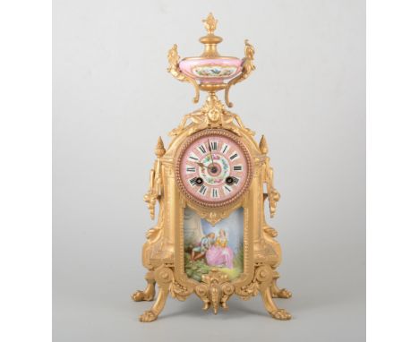 French gilt painted spelter, and Sevres style porcelain mantel clock, in the Transitional style, urn finial, lion paw feet, c