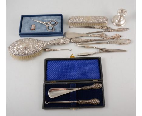 Collection of silver handled button hooks; shoe horn; glove stretchers; dwarf candlestick; scissors and thimble; hair and clo