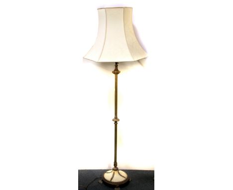 A 1920's gilt brass and onyx standard lamp and shade, H. 167cm.