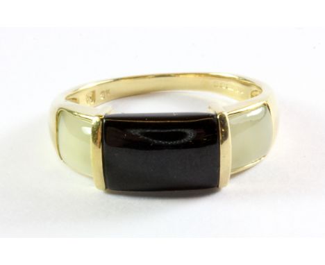 A gentleman's 9ct yellow gold (stamped 9k) onyx and jade set ring, (R).