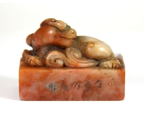 A Chinese caved soapstone seal mounted with a dragon, H. 5cm.