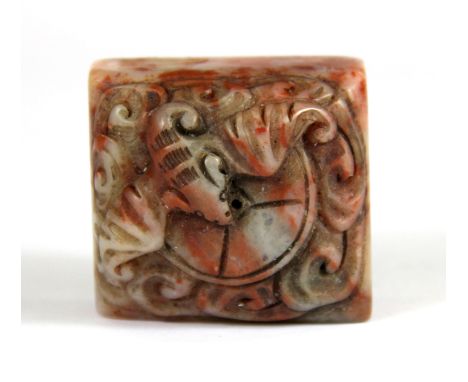 A mid 20th Century Chinese carved soapstone seal mounted with a bat and cash, H. 2.8cm.