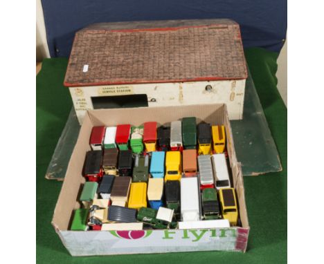 A box of diecast model vehicles and a vintage garage