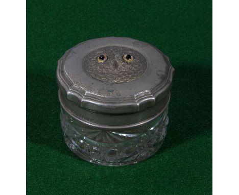 A trinket jar with glass eyed owl lid